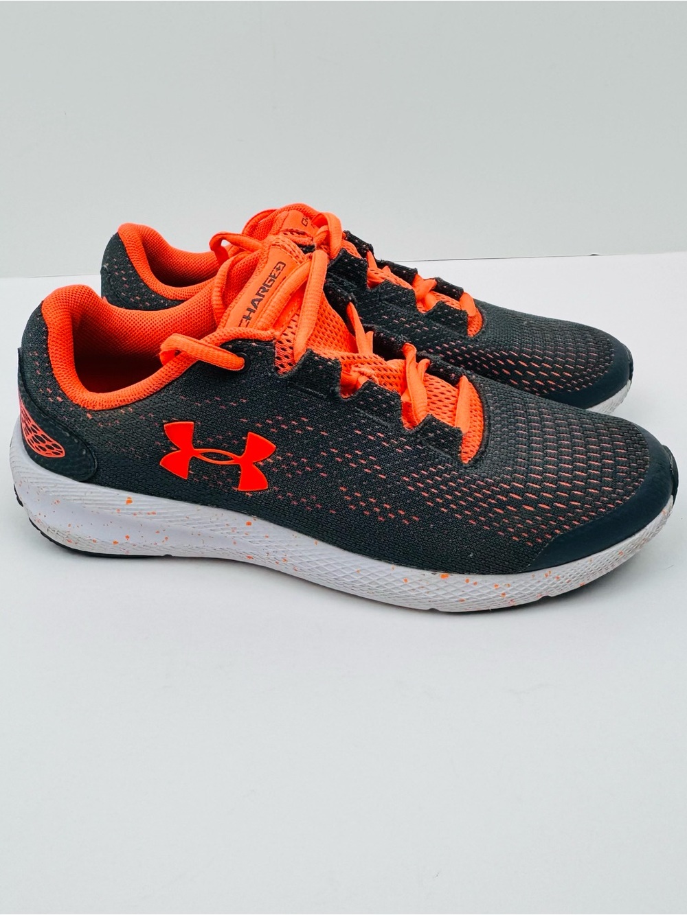 Under Armour Charged Pursuit 2 running shoes . Gray/ orange. Youth size 5.5